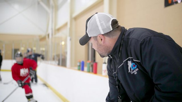 David Cullen watching students on the ice